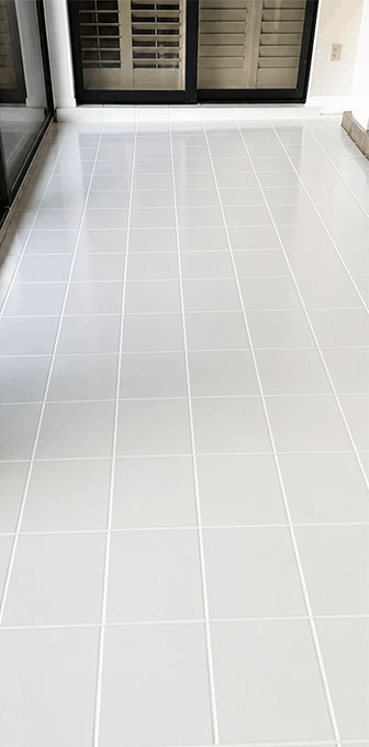 Same shower floor with fresh clean grout after regrouting