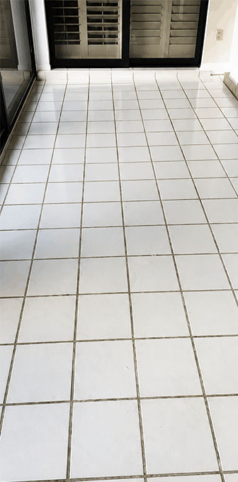 Bathroom shower floor with dirty discoloured grout before regrouting